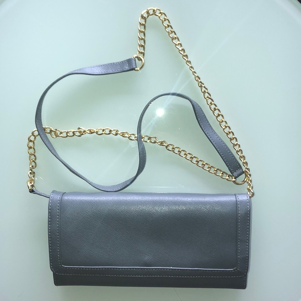 Gray wallet that has removable shoulder strap.